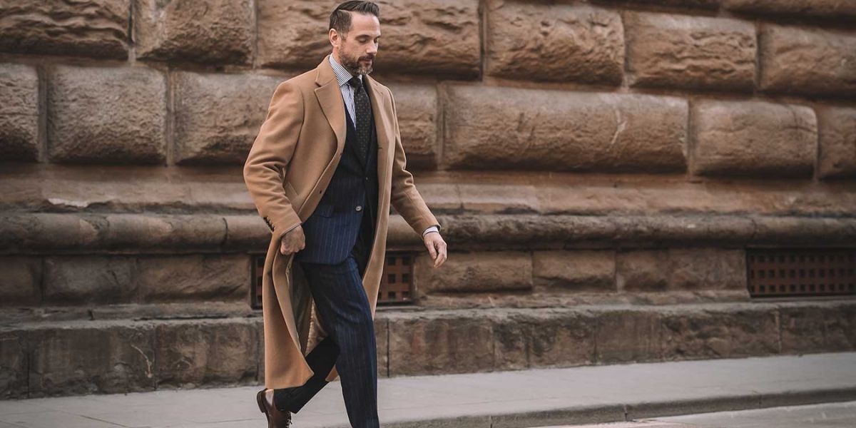 man wearing camel overcoat in winter